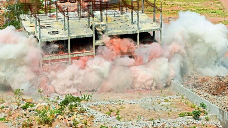 An illegal building at Guttala Begumpet, which GHMC tired to demolish using implosion technology. In its second attempt on Monday, the civic body succeeded to demolish some more part of the structure.   (Photo: DC)