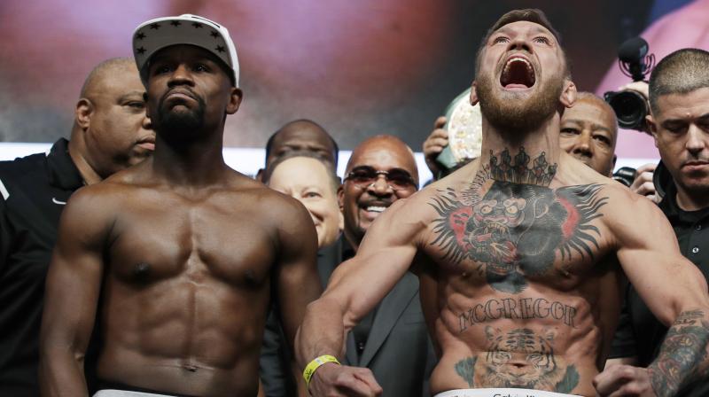 Conor McGregor, 29, will carry a substantial weight advantage into the 12-round boxing contest at the T-Mobile Arena after a raucous weigh-in that saw him face-off with Floyd Mayweather for the final time before fight-night. (Photo: AP)