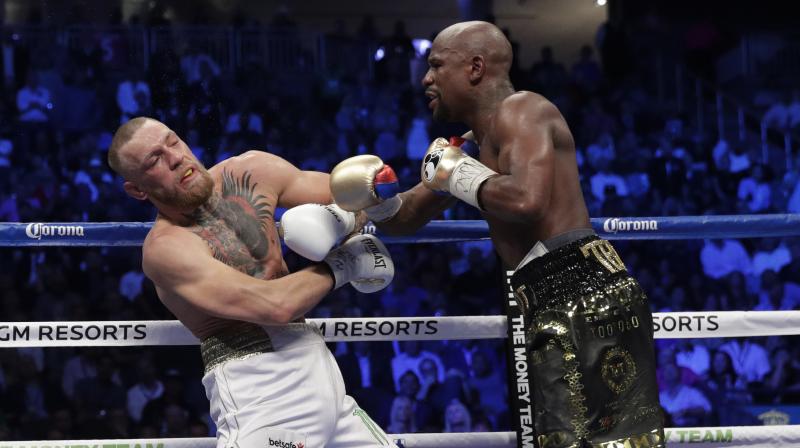 While Conor McGregor (0-1) had the T-Mobile Arena crowd behind his improbable quest, Floyd Mayweather (50-0) survived a rough beginning and gradually took control. (Photo: AP)