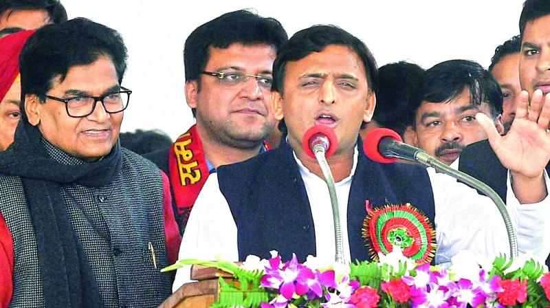Uttar Pradesh Chief Minister and newly-elected partys national president Akhilesh Yadav and party general secretary Ram Gopal Yadav during the Samajwadi Party national convention in Lucknow on Sunday. 	(Photo: PTI)