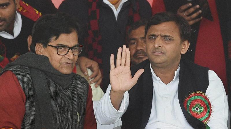 Uttar Pradesh Chief Minister and newly unanimously elected partys national president Akhilesh Yadav and SP general secretary Ram Gopal Yadav during Samajwadi party national convention in Lucknow on Sunday. (Photo: PTI)