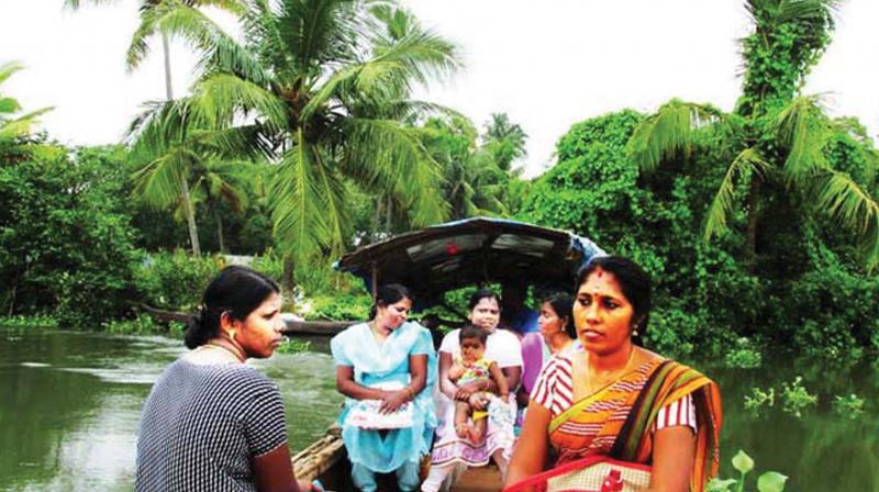 Women travel in small country boats, wash laundry by the waters edge and dry them over twig fences.