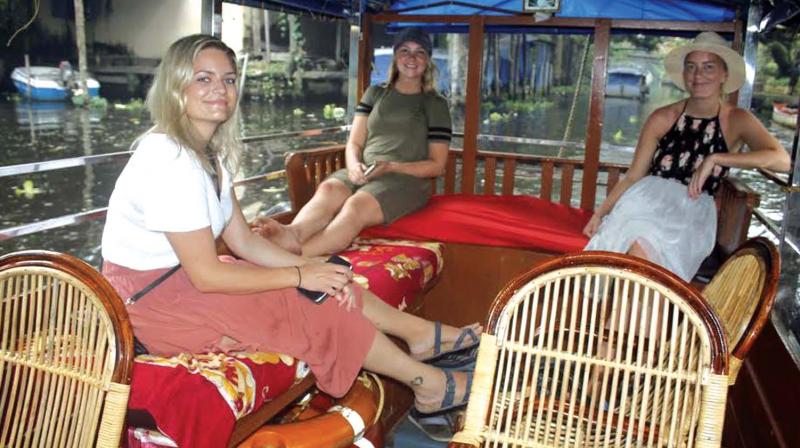 Foreign tourists enjoy cruising on Alappuzha backwaters on Friday. (Photo: DC)