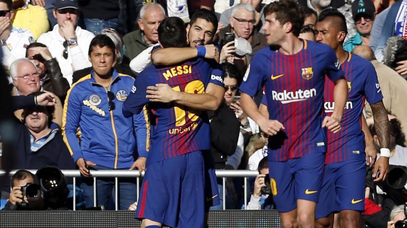 Luis Suarez struck in the 54th minute of the politically charged game and Messi added a penalty 10 minutes later after Madrids Dani Carvajal received a direct red for stopping a goal-bound header by Paulinho.(Photo: AP)