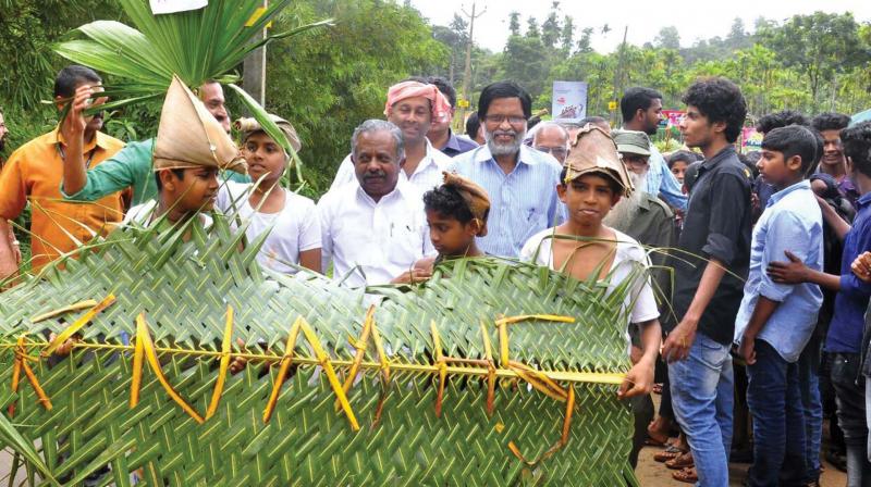 Forest minister K. Raju walks with students after inaugurating the rain walk on Saturday. E.K. Vijayan, MLA, is also seen.