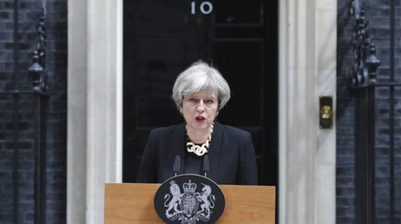 Though national campaigning was suspended on Sunday, British PM May said it would be resumed on Monday and elections would go on as planned. (Photo: AP)