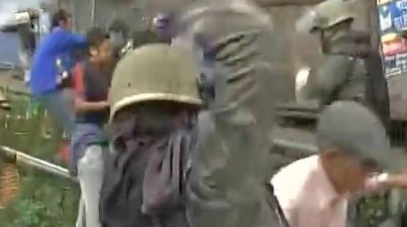 Police resort to lathi charge as GJM supporters pelt stone on forces. (Photo: ANI | Twitter)