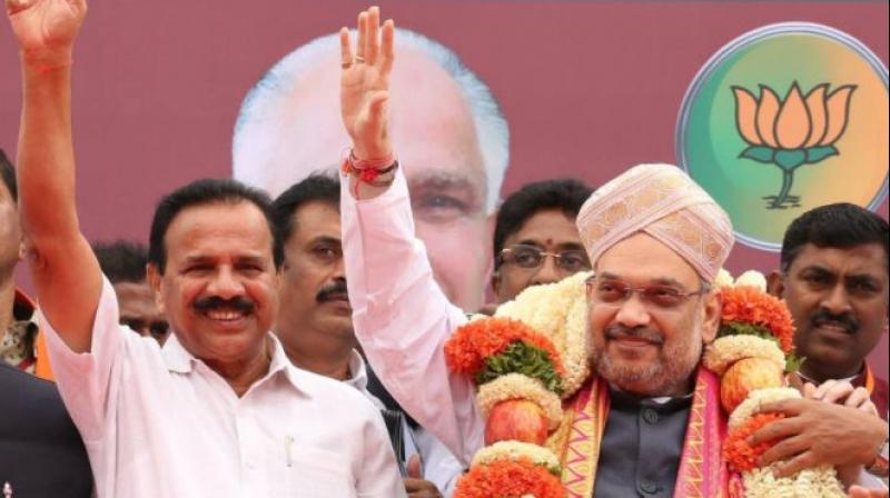 BJP president Amit Shah arrived in Bengaluru on Saturday on a three-day visit to Karnataka to re-energise the rank and file, and asserted that the party stood united and would return to power in next years assembly polls under the leadership of state unit chief B S Yeddyurappa. (Photo: Twitter | @AmitShah )