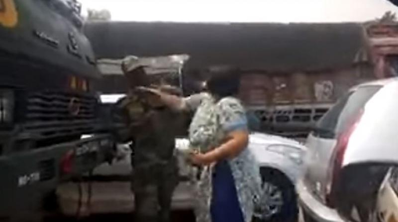 A woman slapping and abusing a soldier relentlessly, without facing any resistance at all