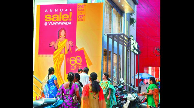Poster advertising discount sale at a textile showroom in Vijayawada. (Photo: DC)
