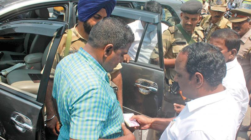 Bypoll flying squad along with CISF police personnel checks cars at RK Nagar on Thursday. (Photo: DC)