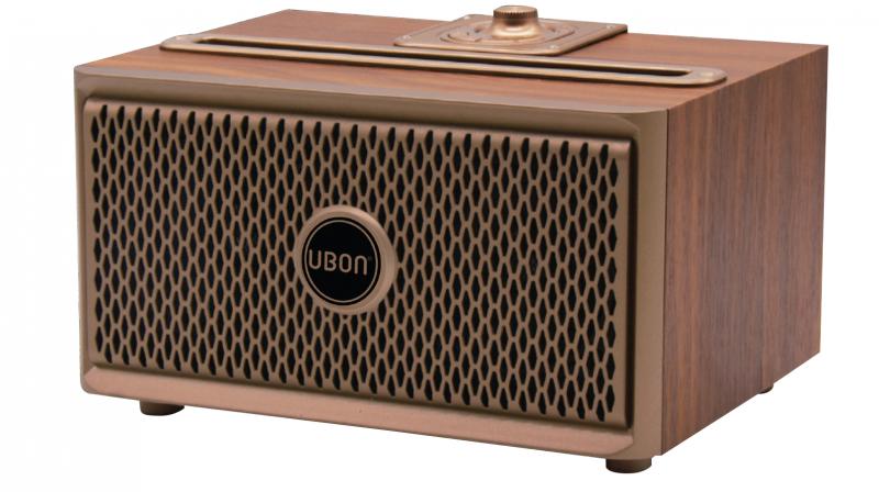 The UBON SP-50 Wooden wireless speaker can be carried into a backpack, suitcase, or travel bag.