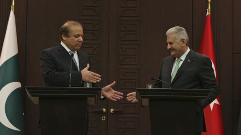 Pakistans Prime Minister Nawaz Sharif, left, reaches out to shake hands with Turkeys Prime Minister Binali Yildirim, right, after their remarks following their meeting in Ankara on Thursday. (Photo: AP)