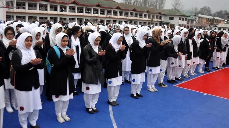 Students greet each other in schools as they meet their classmates as schools re-opened in Srinagar on Wednesday after winter vacation. (Photo: Habib Naqash)