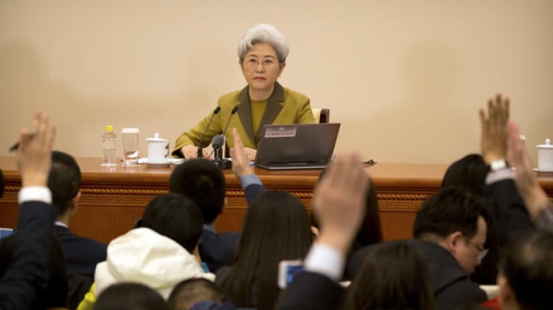 Journalists raise their hands to ask a question of Fu Ying, spokeswoman for Chinas National Peoples Congress, during a press conference held at the Great Hall of the People in Beijing.