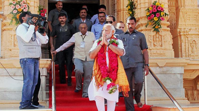 Prime Minister Narendra Modi coming out of the Somnath Temple in Gujarats Gir-Somnath district. (Photo: PTI)rendra Modi waving to the crowd during his roadshow in Varanasi. (Photo: ANI Twitter)