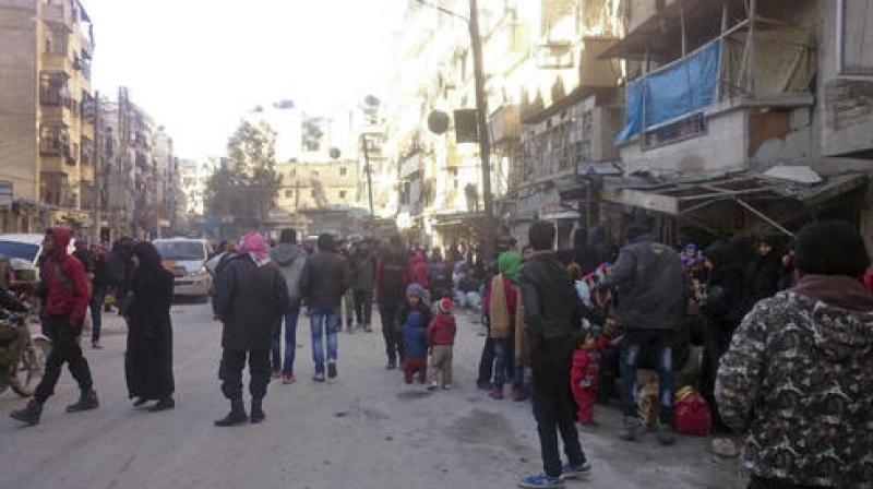 A slow-moving convoy of around two dozen vehicles snaked out of Al-Amiriyah district and crossed into government-held Ramussa en route to rebel-held territory in the west of Aleppo province. (Photo: AP)