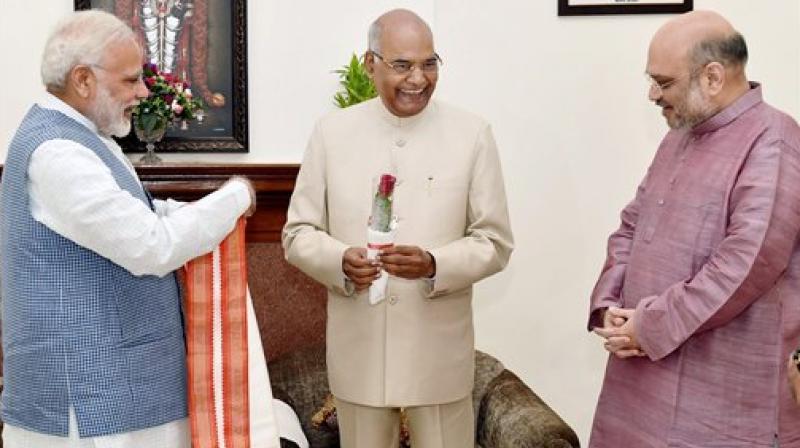 Prime Minister Narendra Modi and BJP President Amit Shah greet Ram Nath Kovind on being elected as the 14th President of India. (Photo: PTI)