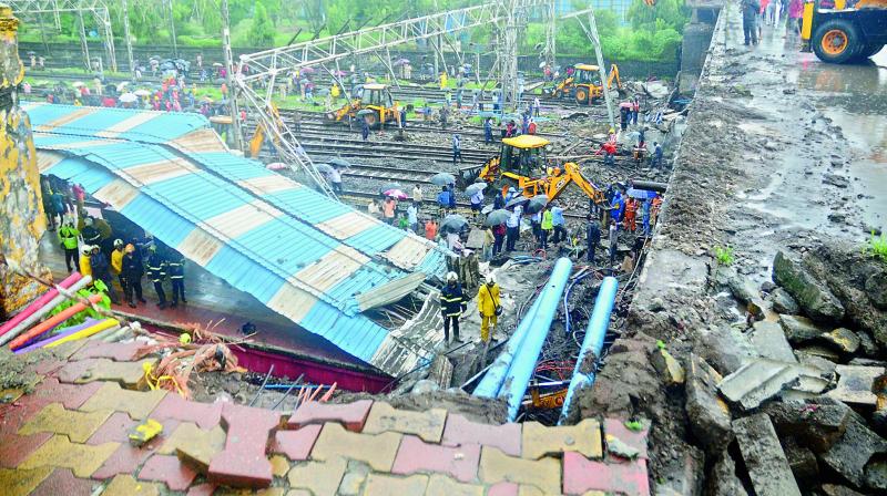 A view of the road overbridge that collapsed on the railway track near Andheri Railway station amid heavy rains in Mumbai on Tuesday. (Photo: Shripad Naik)