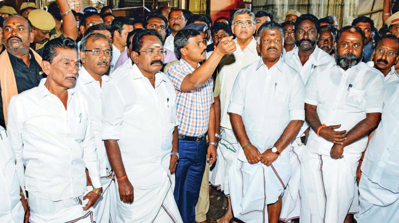 Collector K. Veera Ragava Rao explains to Deputy CM O. Panneerselvam about the fire mishap at Meenakshi Amman temple in Madurai on Monday. Ministers Sellur K. Raju and R.B. Udhayakumar are also present. (Photo: DC)