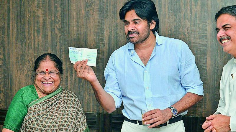 Jana Sena chief Pawana Kalyans mother Anjana Devi presents Rs 4 lakh cheque for Jana Sena in Hyderabad.