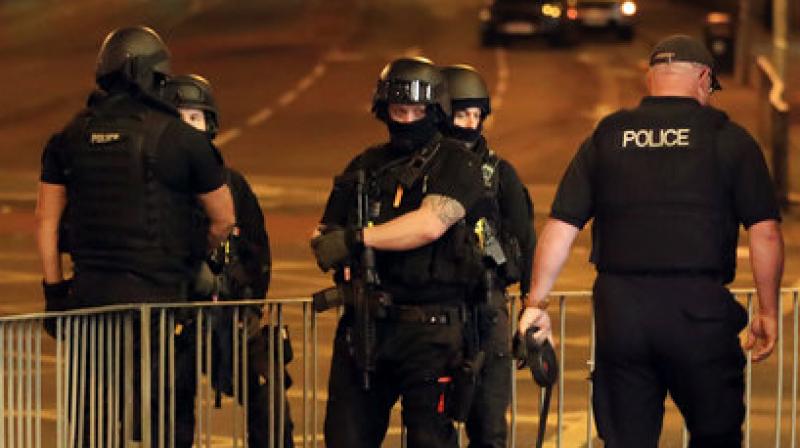Armed police work after an explosion at the Manchester Arena in England (Photo: AP)