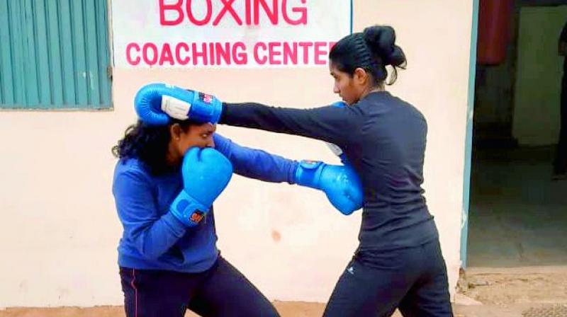 Young pugilists spar during a training session at the IGMC Stadium in Vijayawada on Monday. (Photo:DC)