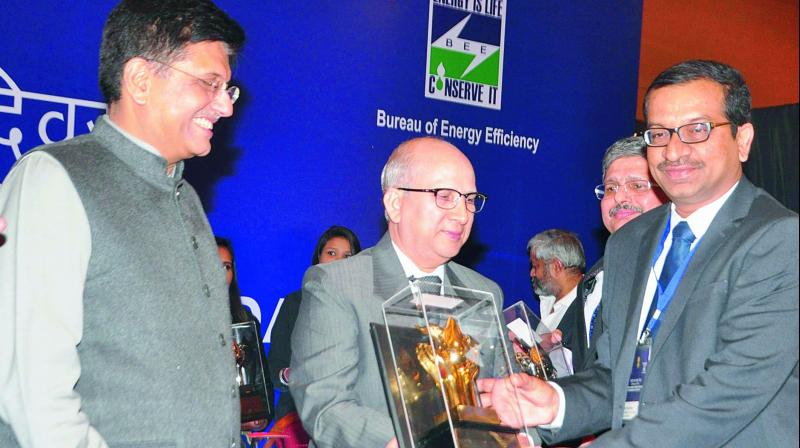 EPDCL CMD M.M. Naik receives award in the national level competition in energy conservation as Union power minister Piyush Goyal looks on in New Delhi on Wednesday.