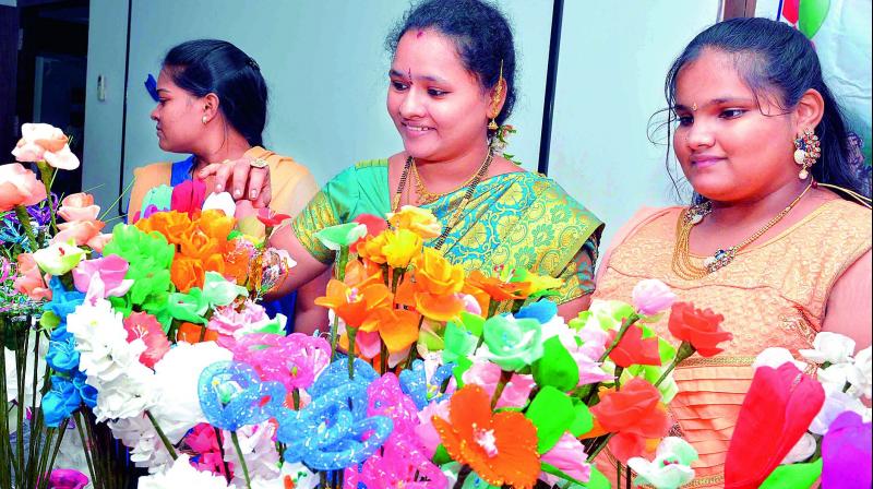 Women showcase artificial flowers at the Arts and Crafts Training and Exhibition in Vijayawada on Wednesday.  (Photo: DECCAN CHRONICLE)
