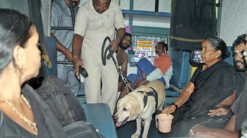 Anti-sabotage team, with help of a sniffer dog, inspects the train after they received a hoax bomb call in the city on Friday. (Photo: DC)