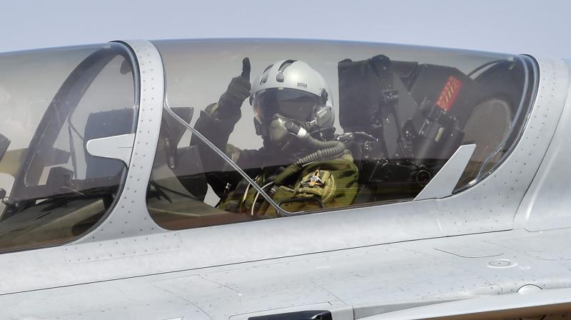 Reliance Group Chairman Anil Ambani showing thumbs up sign as he sit inside the cockpit of Rafale aircraft before a sortie during the 2nd day of the 11th biennial edition of AERO INDIA 2017 at Yelahanka Air base in Bengaluru. (Photo: PTI)