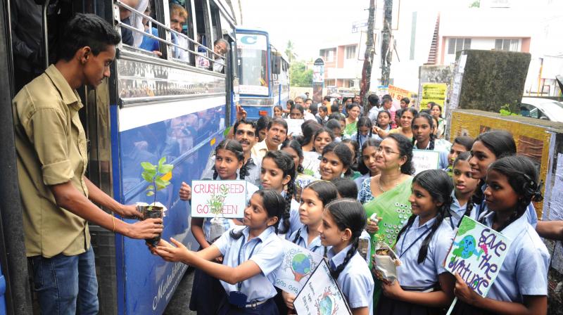 Students of St Antonys High School, Kacherippaddy, distribute plant saplings as part of observing the World Environment Day on Monday.  (Photo: ARUN CHANDRABOSE)