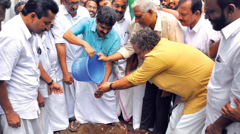 Actor Joy Mathew being helped by DCC chief T. Siddique to plant a sapling on Monday. (Photo: Viswajith K)