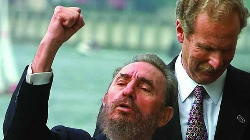 A file photo of Cuban revolutionary leader Fidel Castro (left) shouting a slogan as he raises his fist during the VIII Ibero-American Summit group picture in Oporto in 1998. (Photo: AP)