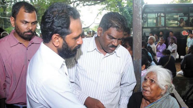 Ammini, mother of Kuppu Devaraj with brother Sreedharan (middle) and human rights activist Nirmal Thushar Saradhy in front of mortuary at MCH, Kozhikode on Saturday.