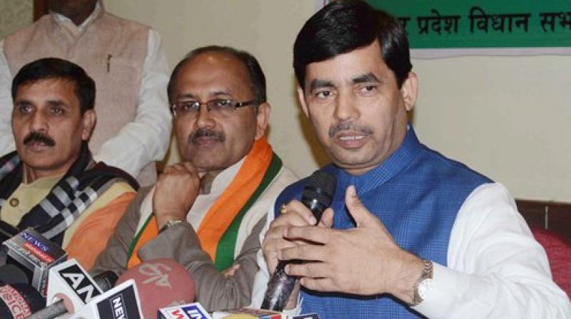 Bharatiya Janata Party spokesperson Shahnawaz Hussain with party leader Siddharth Nath Singh during a press conference in Allahabad. (Photo: PTI)