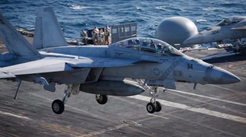 he flight deck of the USS Carl Vinson shakes as a succession of F-18 fighter jets are catapulted into take-off, emitting a thunderous noise and leaving white mist in their wake. (Photo: AP)