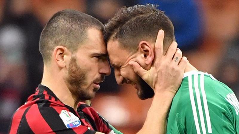 Gianluigi Donnarumma was in tears as he was comforted by teammate Leonardo Bonucci(Photo: AP)