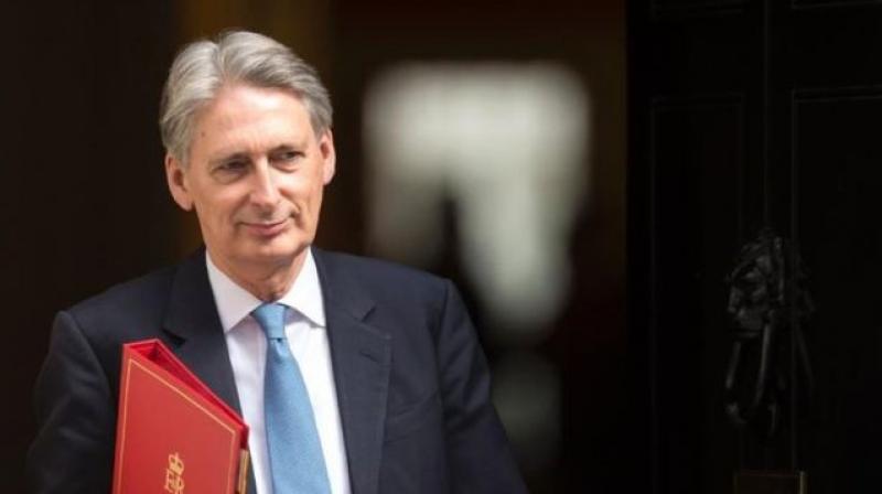 Chancellor Philip Hammond and Home Secretary Amber Rudd have struck a deal to raise the Home Office budget from 707 million pounds to 757 million pounds in 2018. (Photo: AFP)