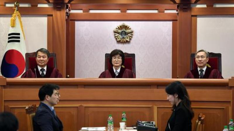 Judges of South Koreas Constitutional Court, from left to right, Lee Jin-Sung, Lee Jung-Mi and Kang Il-Won, sit on during a hearing into whether to confirm the impeachment of President Park Geun-hye, at the Constitutional Court in Seoul. (Photo: AP)
