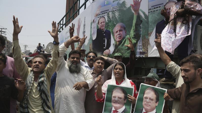 Supporters of Pakistani former prime minister Nawaz Sharif chant slogans for their leader in Lahore, Pakistan on Friday. (Photo: AP)
