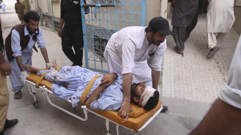 People rush an injured person to a hospital in Quetta, Pakistan on Friday. (Photo: AP)