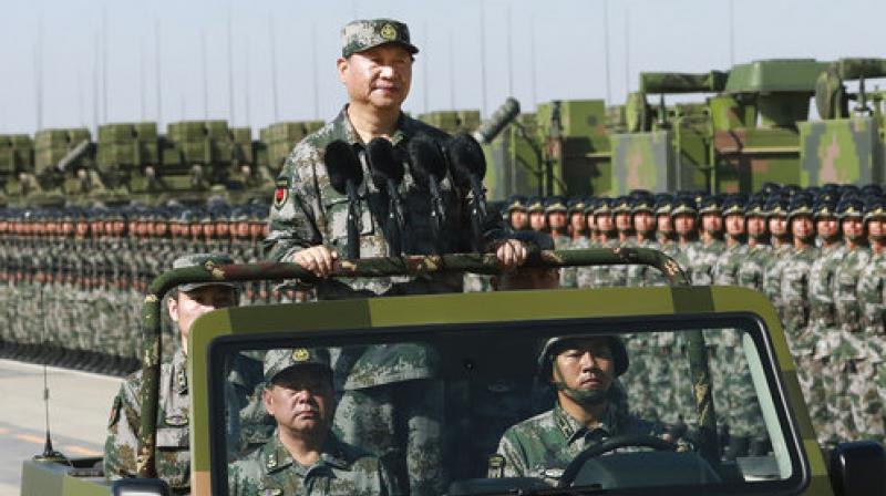 Chinese President Xi Jinping stands on a military jeep as he inspects troops of the Peoples Liberation Army during a military parade to commemorate the 90th anniversary of the founding of the PLA at Zhurihe training base in north Chinas Inner Mongolia Autonomous Region (Photo: PTI)