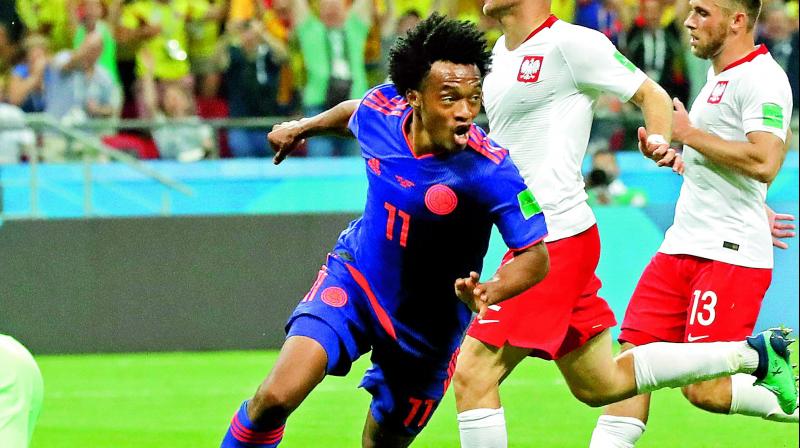 Juan Cuadrado of Colombia celebrates after scoring his sides third goal during the Group H match against Poland at the Kazan Arena on Sunday. (Photo: AP)