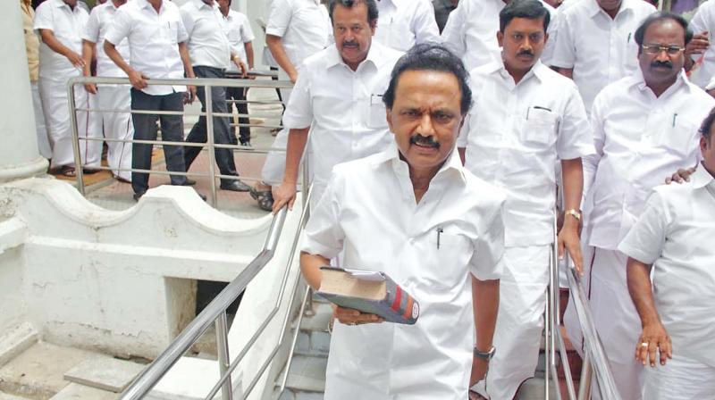 DMK working president M.K. Stalin walks out of the state assembly on Monday with his party members. (Photo: DC)