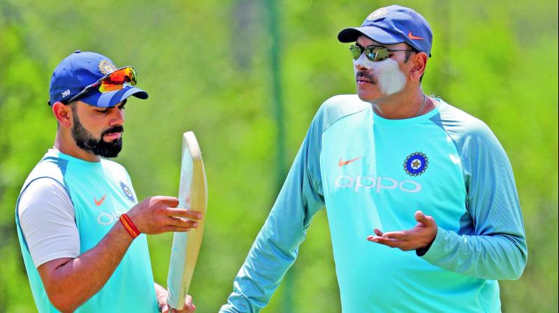 India captain Virat Kohli (left) intracts with coach Ravi Shastri during a practice session at the Wanderers Stadium in Johannesburg ahead of the third and final Test match against South Africa. (Photo: AP)