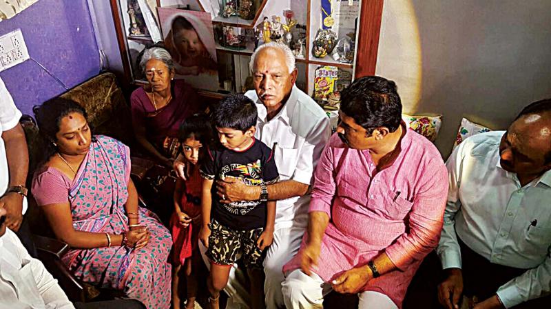 BJP state president B.S. Yeddyurappa and party leader R. Ashok with Rudreshs family in Bengaluru on Thursday (Photo: KPN)