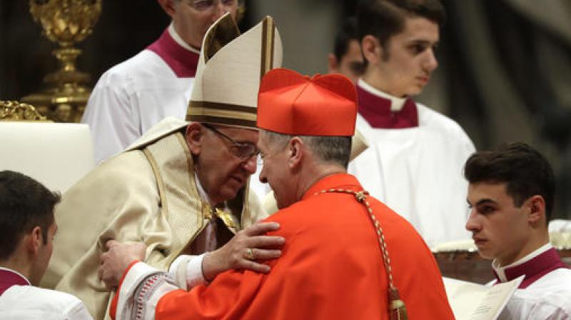 Dressed in red robes, the princes of the Church knelt before the pontiff to pledge their allegiance in a solemn ceremony. (Photo: AP)