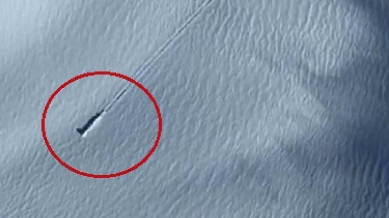 Theorists at a popular alien site zoomed in on the images to find tracks running behind it (Photo: YouTube)