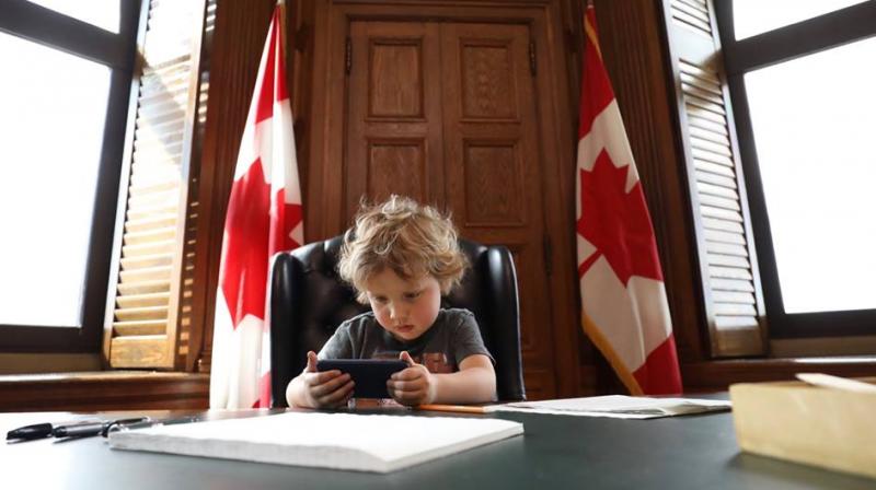 Cuteness personified! Justin Trudeaus son accompanies him to office